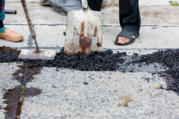 istock Street resurfacing. Fresh asphalt construction. Bad road. Construction site is worker laying repair asphalt road. Covering the pit 1398788165
