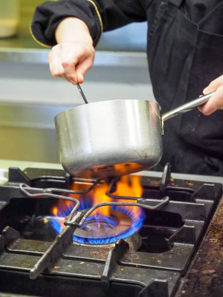 istock hand of chef with spoon on a pot kitchen fired gas 1398788207