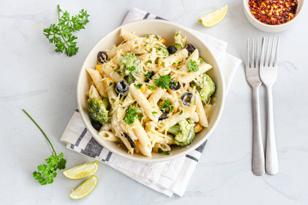 White Sauce Penne Pasta Directly Above Photo White Sauce Penne Pasta with Vegetables Garnished with Fresh Parsley Top Down Photo Pasta stock pictures, royalty-free photos & images