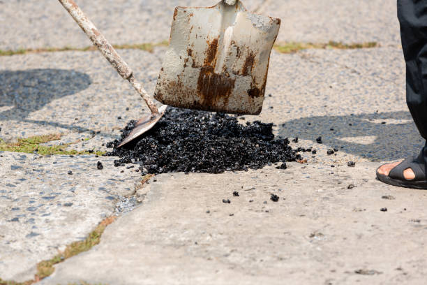 istock Street resurfacing. Fresh asphalt construction. Bad road. Construction site is worker laying repair asphalt road. Covering the pit 1398788390