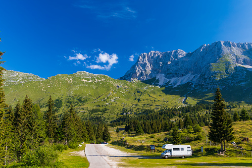 Caravan in summer mountain landscape, Alps, Italy