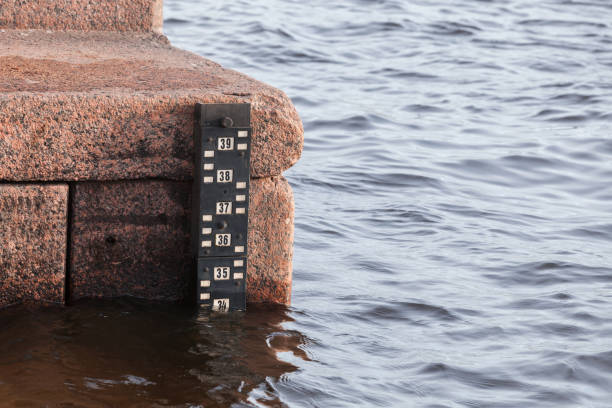Tide gauge scale mounted on the Neva river bank, Saint-Petersburg, Russia