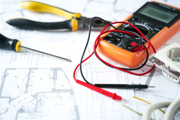 istock Making repairs,planning electricity project in house.Drawings,diagrams,plan for electrification of apartment, building. Devices and accessories, voltmeter, wires, screwdriver, pliers and tape measure 1398789801