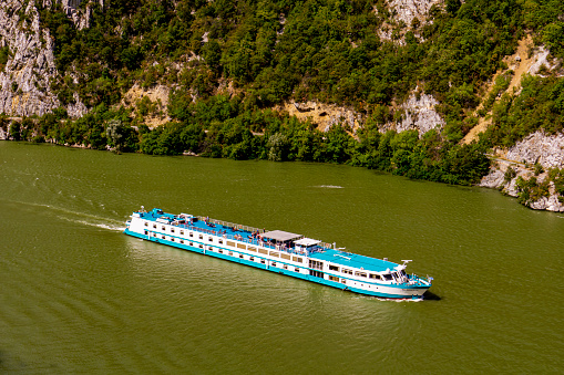 Cruise ship on river Danube in Djerdap gorge in Serbia. At 2016 118 cruise ships with more than 18.000 tourists visited Djerdap National Park.