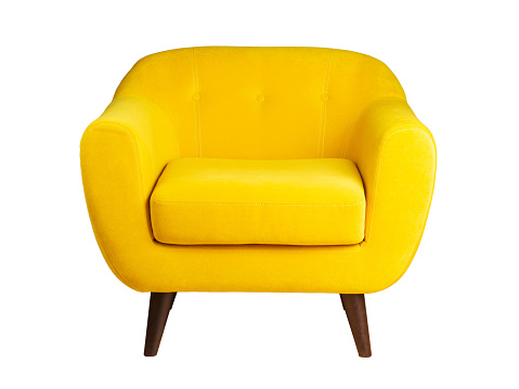 wide yellow upholstered armchair with fabric upholstery on wooden legs in retro style, isolated on a white background
