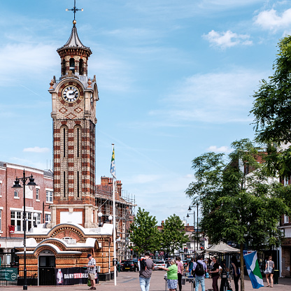 Epsom Surrey, London UK, May 22 2022, Epsom Clock Tower In The Market Square With People Under A Clear Blue Sky