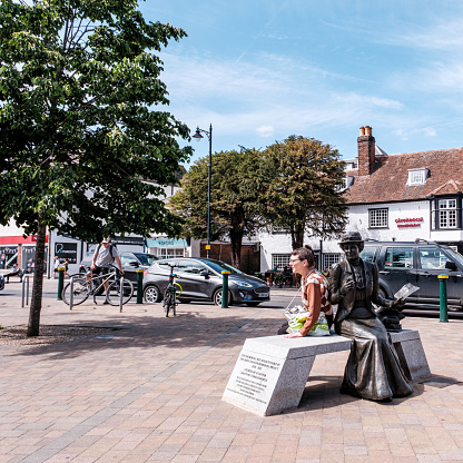 Epsom Surrey, London UK, May 22 2022, Statue of Suffragette Emily Davison Killed At Epsom Derby With Pedestrian Sitting Next To Her In Market Square