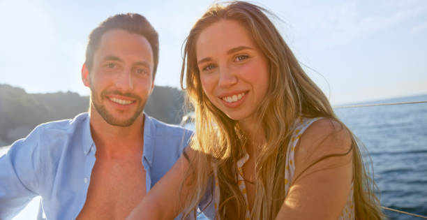 istock Happy couple sitting on sail boat 1398792899