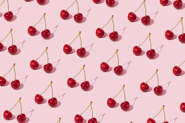 istock Summer pattern made of fresh cherries on pink background. Minimal concept. 1398792937