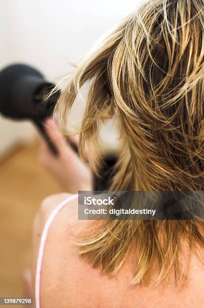 Woman Drying Hair With A Hairdryer Stock Photo - Download Image Now - Adult, Beauty, Blond Hair