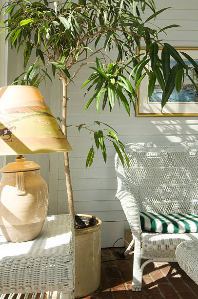 Sunlit porch with white wicker stock photo