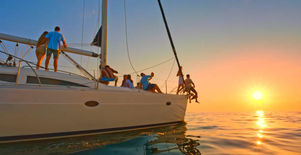 istock Friends sitting on sailboat 1398793103