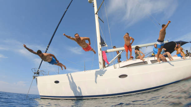 istock Friends jumping in sea 1398793540