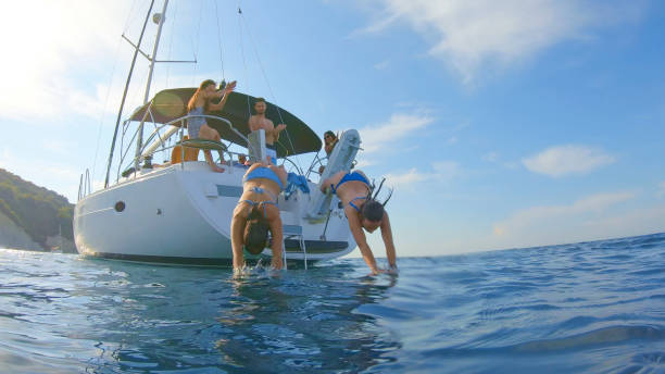 istock Women jumping in sea 1398793581
