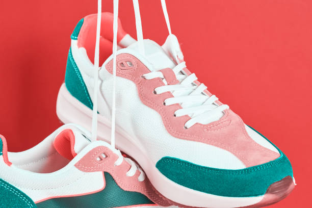 istock Stylish trendy shoes on red background 1398796135