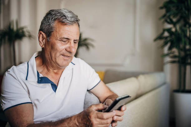 istock A mature man surfs the internet, uses a smartphone 1398796310