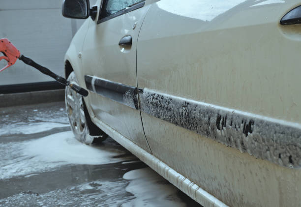 istock Car wash. High pressure washer. Vehicle covered with foam. 1398797828