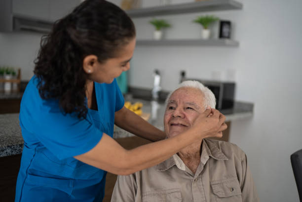 istock Nurse taking care of senior man at home 1398802467