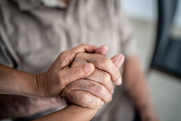istock Senior man and woman holding hands 1398802495