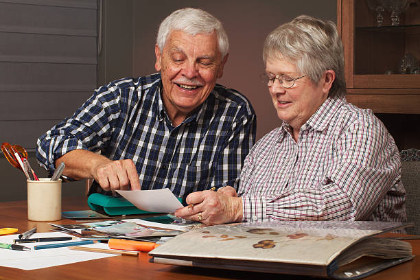 istock Happy senior couple making a scrapbook 139880261