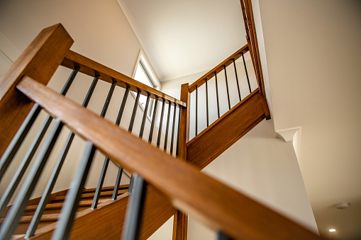 Wooden interior stairs staircase structure with brown colour, modern style and light window, up view