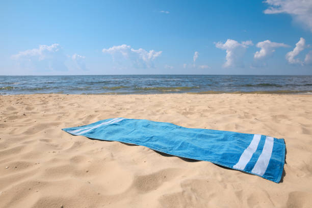 istock Blue striped beach towel on sandy seashore 1398805280