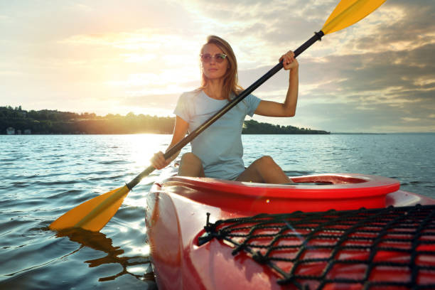istock Beautiful woman kayaking on river. Summer activity 1398805408