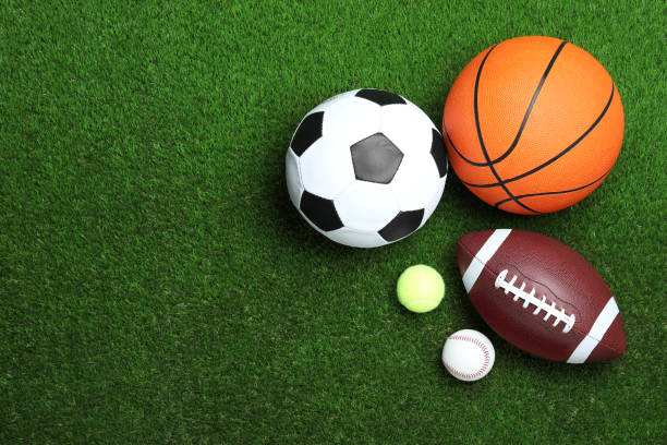 istock Set of different sport balls on green grass, flat lay. Space for text 1398805490