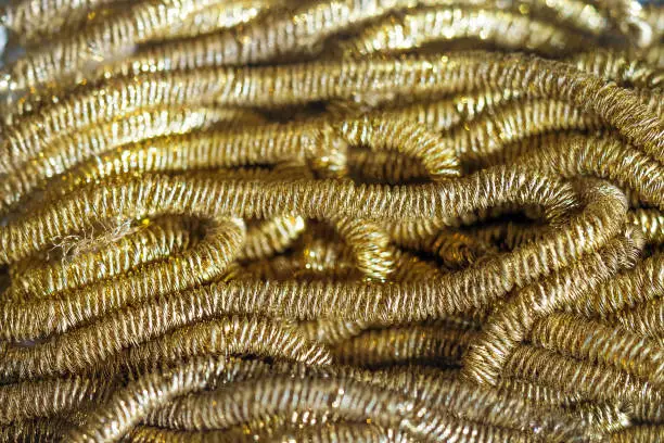 Photo of Golden rigmarole or truncal background. Soft, curly texture