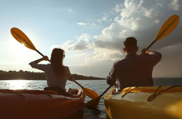 istock Beautiful couple kayaking on river, back view. Summer activity 1398805504