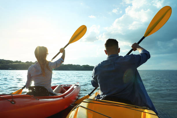 istock Beautiful couple kayaking on river, back view. Summer activity 1398805507