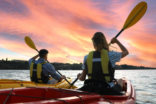 istock Couple in life jackets kayaking on river, back view. Summer activity 1398805558