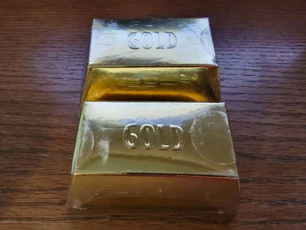 gold bars or blocks on wood desk or surface gold bars or blocks on wood desk or surface or table solid gold bars for sale stock pictures, royalty-free photos & images
