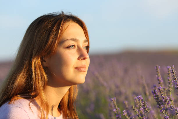 istock Woman relaxing contemplating sunset from lavender field 1398806849