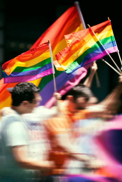New York, USA: June 29th 2014; Participants waving rainbow flags at the New York LGBTQ parade in motion