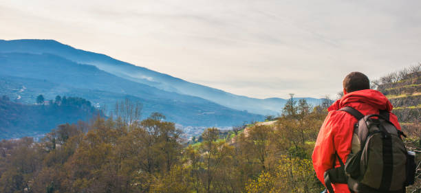 istock Trekker man observing Jerte Valley seen from Nogaleas, Navaconcejo, Caceres, Spain 1398807019