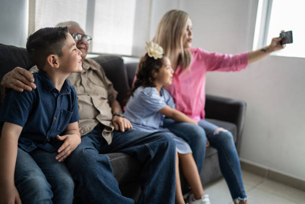 istock Multi generation family taking selfies using mobile phone at home 1398807184