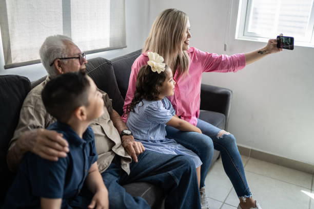 istock Multi generation family taking selfies using mobile phone at home 1398807277