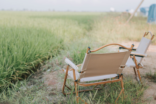 2 camping chair facing paddy field in day time