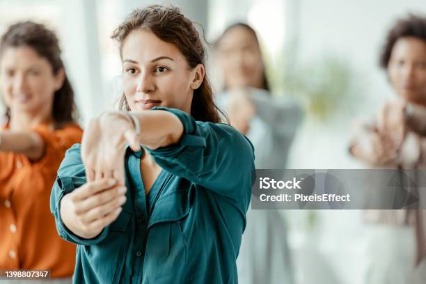 Businesswomen Stretching In The Office Stock Photo - Download Image Now - Office, Exercising, Relaxation Exercise