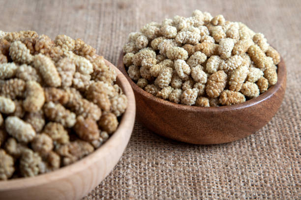 istock Bowl full of dried mulberry on a fabric background 1398808534