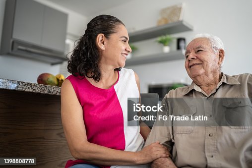 istock Senior man and his daughter (or home caregiver) talking at home 1398808778