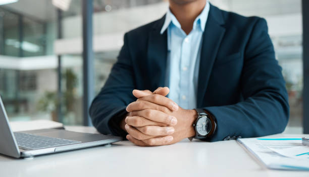 istock Businessman working on a laptop alone at work. One content businessperson looking ready while sitting at a desk in an office 1398809575