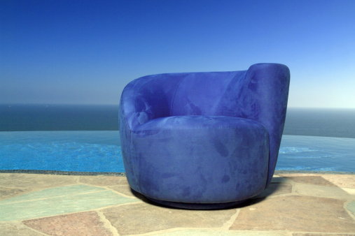chair by pool overlooking pacific ocean
