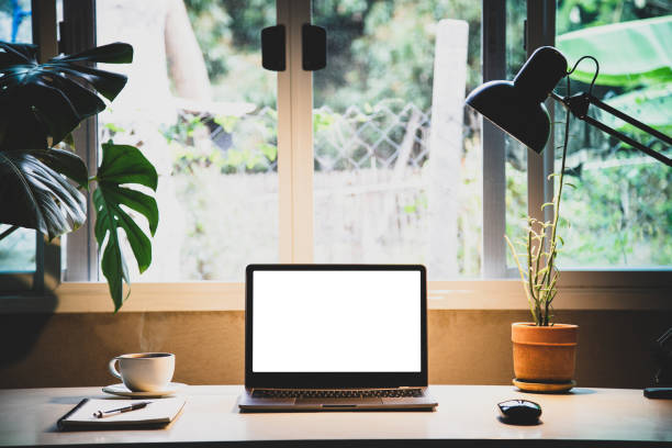 istock Mockup laptop devices home office. personal computer notebook white screen. and coffee cup, houseplant, notepaper as a desk in the morning 1398810788