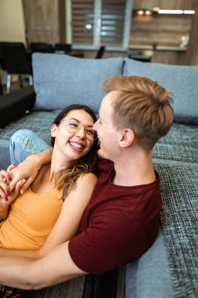 istock Romantic couple cuddling in living room 1398811659