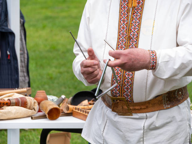 musician man plying triangle striking beater. ukraininan idiophone metal ethnic musical instrument. folk music festival - dulcimer imagens e fotografias de stock