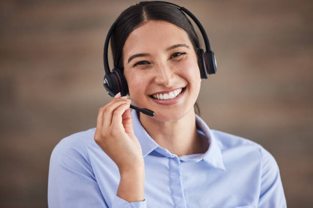 Face of businesswoman working in a call center. Customer service operator wearing a headset. Portrait of happy service rep. IT customer service rep. Smiling customer service agent on a call Face of businesswoman working in a call center. Customer service operator wearing a headset. Portrait of happy service rep. IT customer service rep. Smiling customer service agent on a call virtual assistant stock pictures, royalty-free photos & images