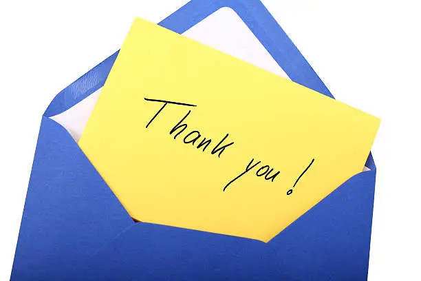 Digital photo of a blue envelope with a letter with the words thank you.