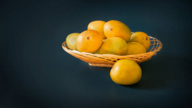 istock mangoes in basket blue dark background 1398814287